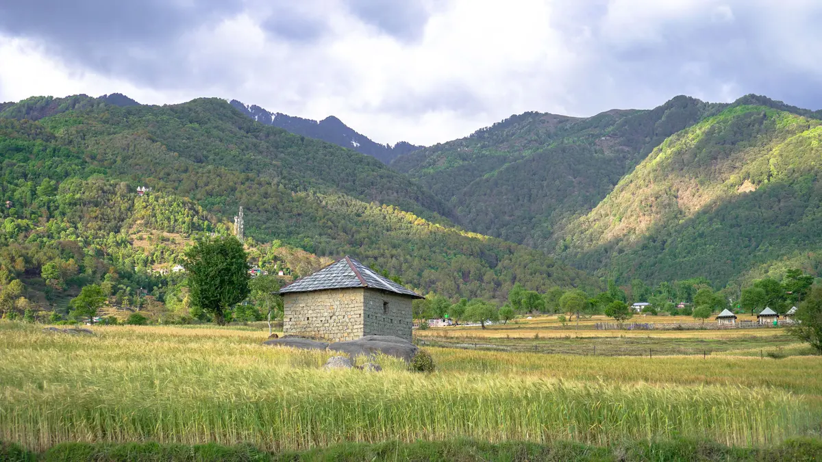 A stone hut in the green valley below Bir