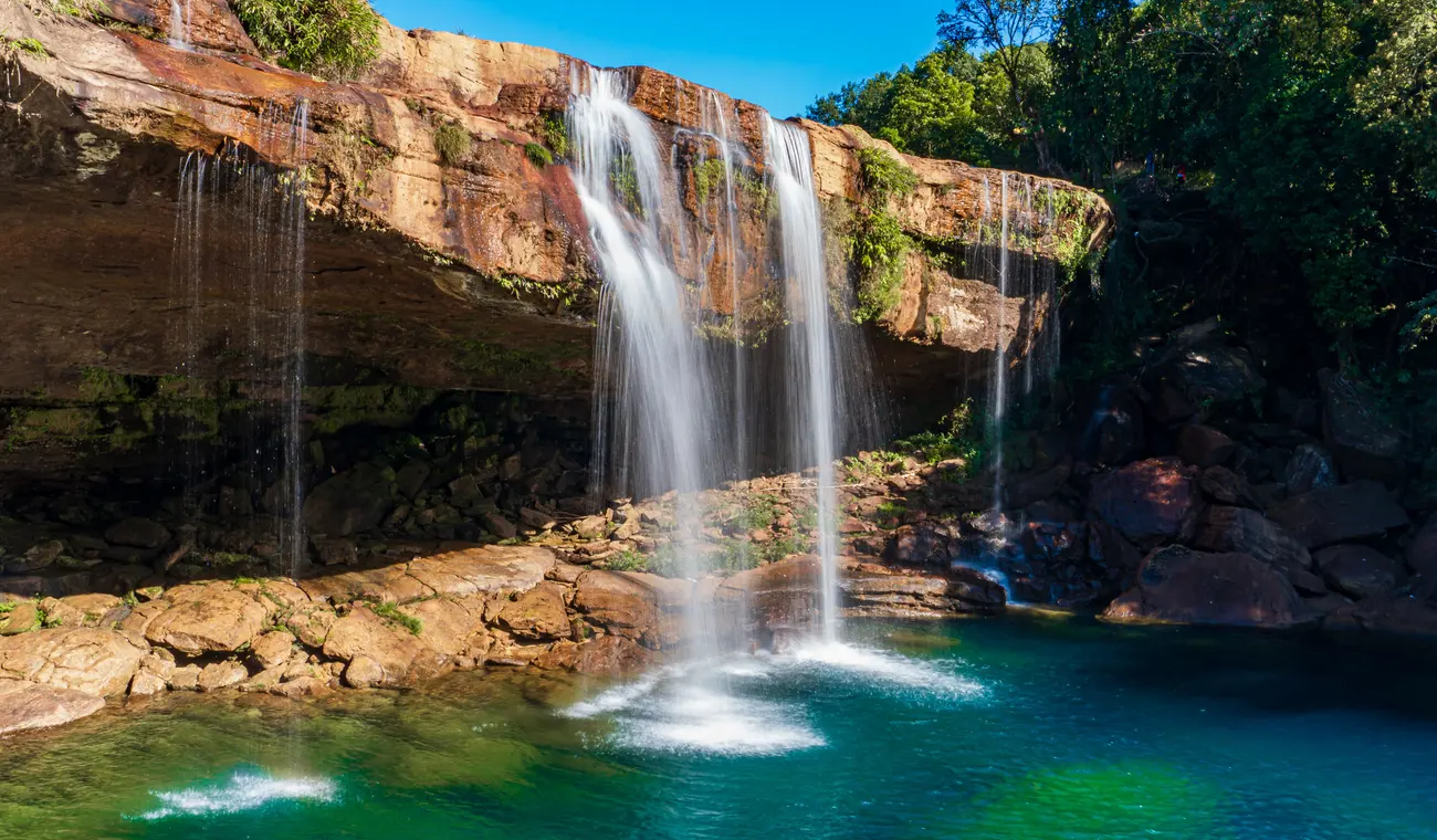 Krang Suri Falls cascading into a turquoise pool in the Jaintia Hills