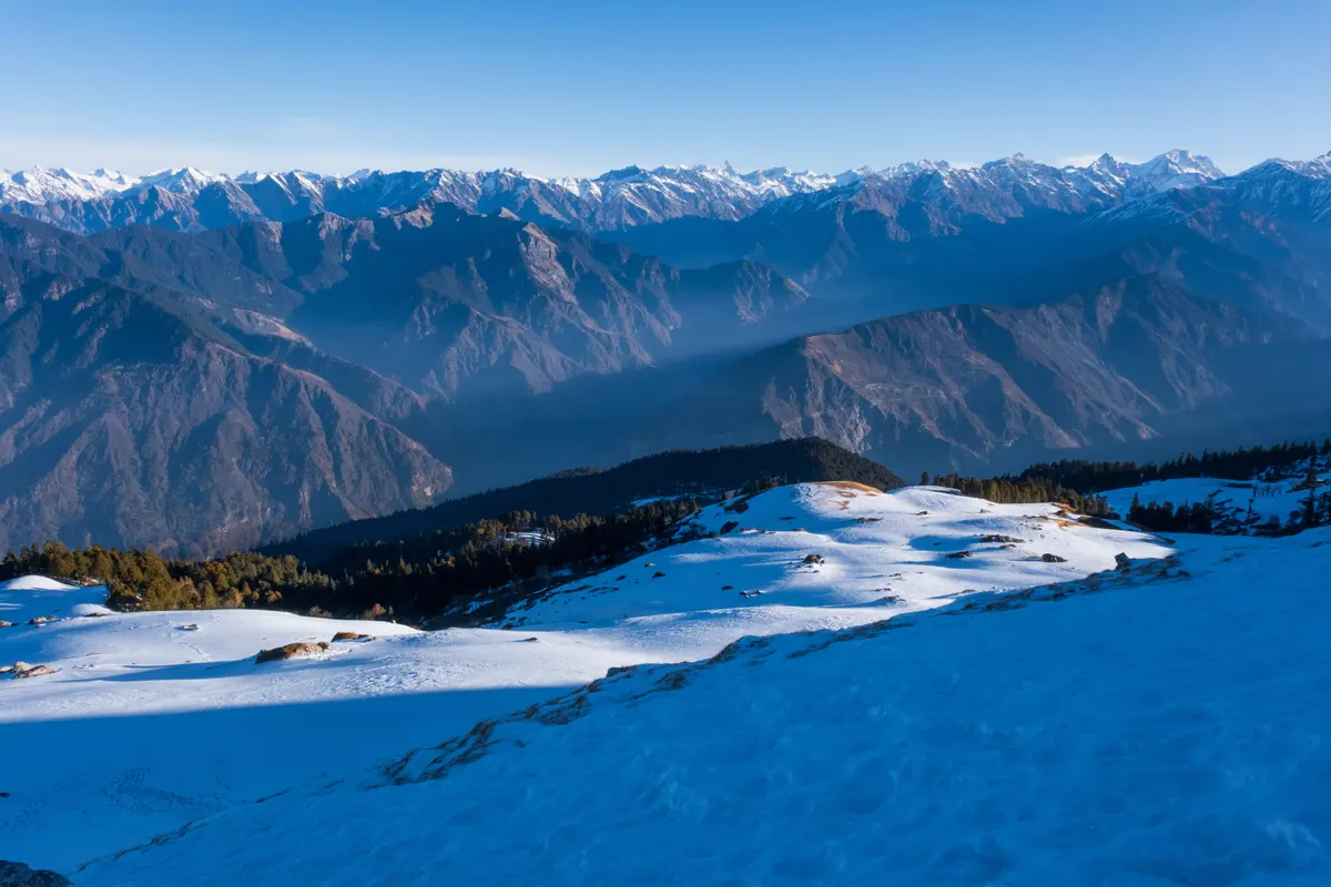 Panoramic view of the snow-capped Himalayan range from Kedarkantha