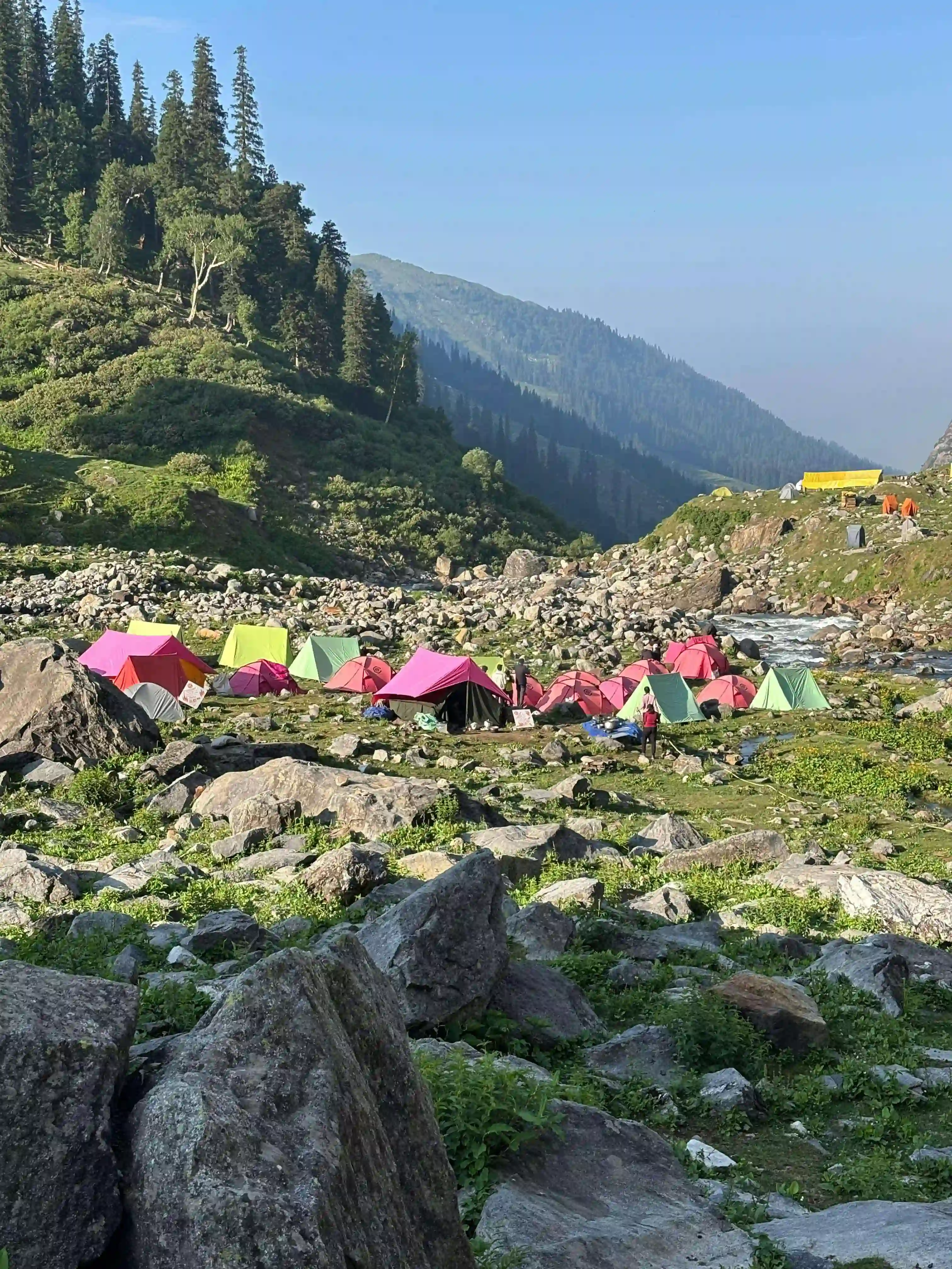 Trekking group crossing a stream en route to Hampta Pass