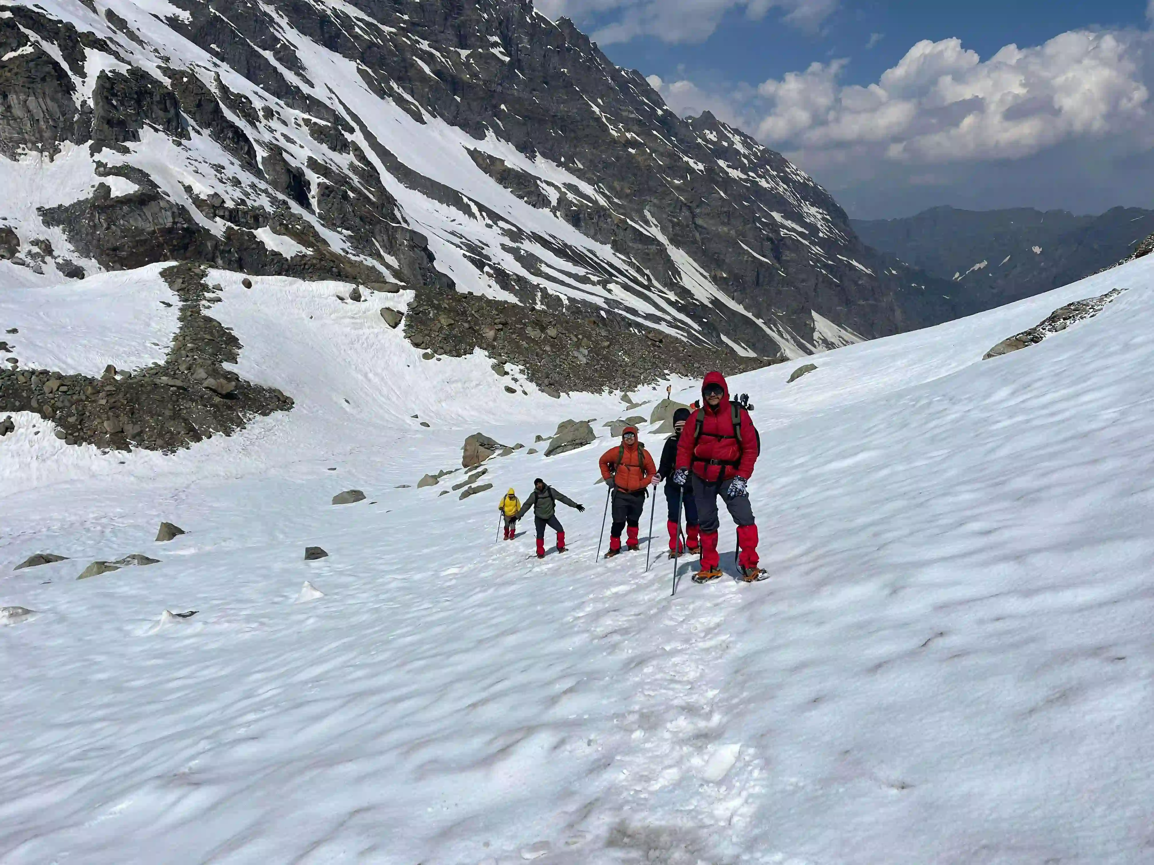 Hiker atop Hampta Pass with valley views below