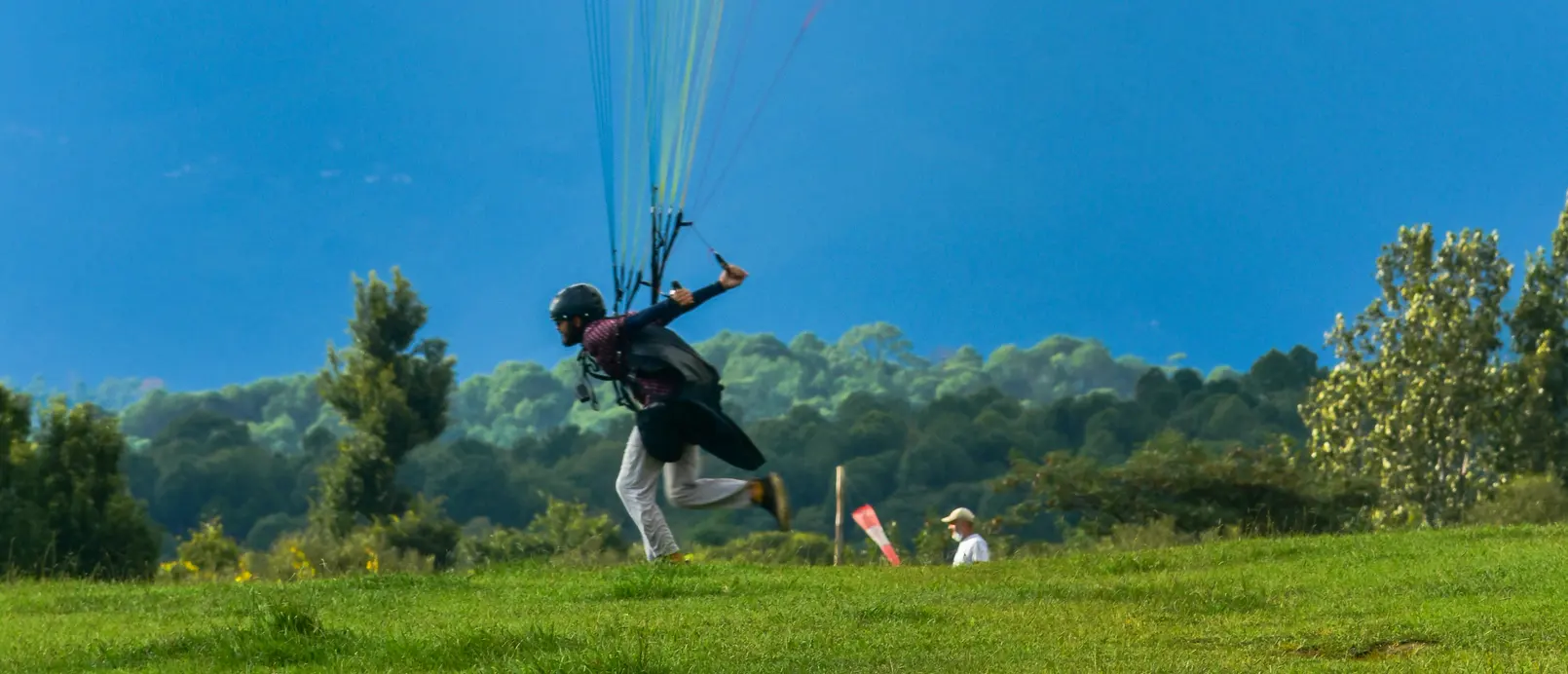 Paraglider landing safely in the fields below Billing