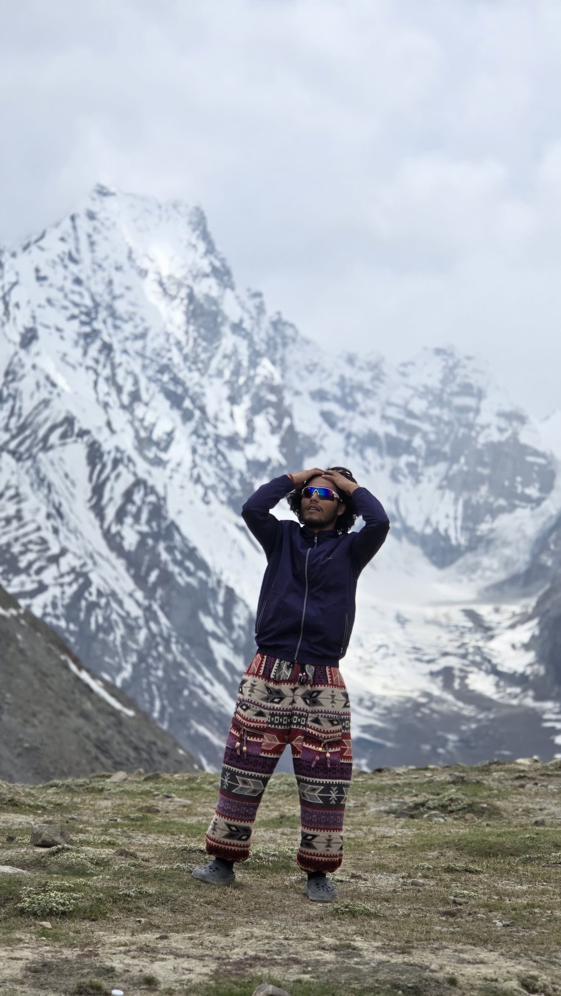 A TripoMusafir traveller before a snow capped Spiti peak