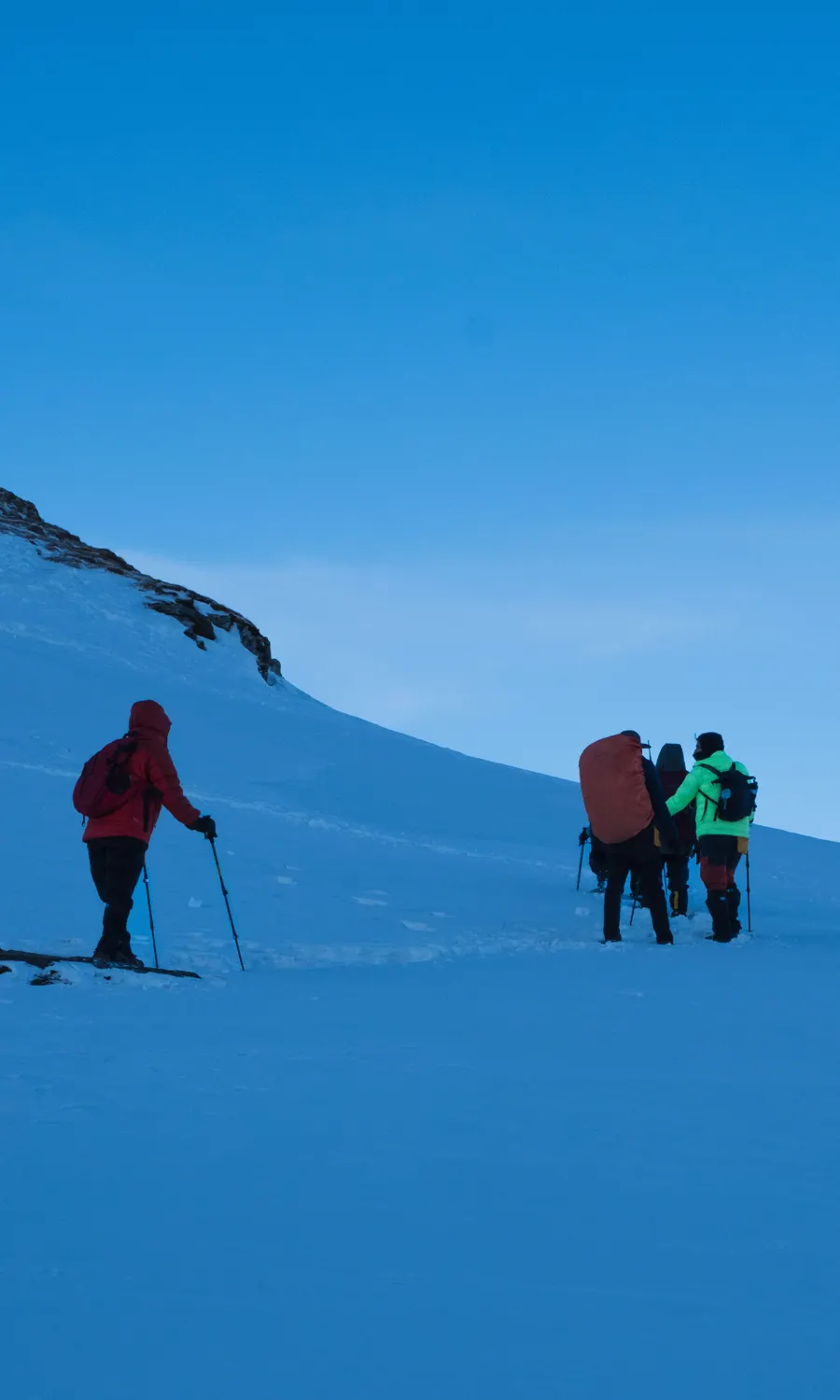 Descending the summit ridge in the pre-dawn blue light