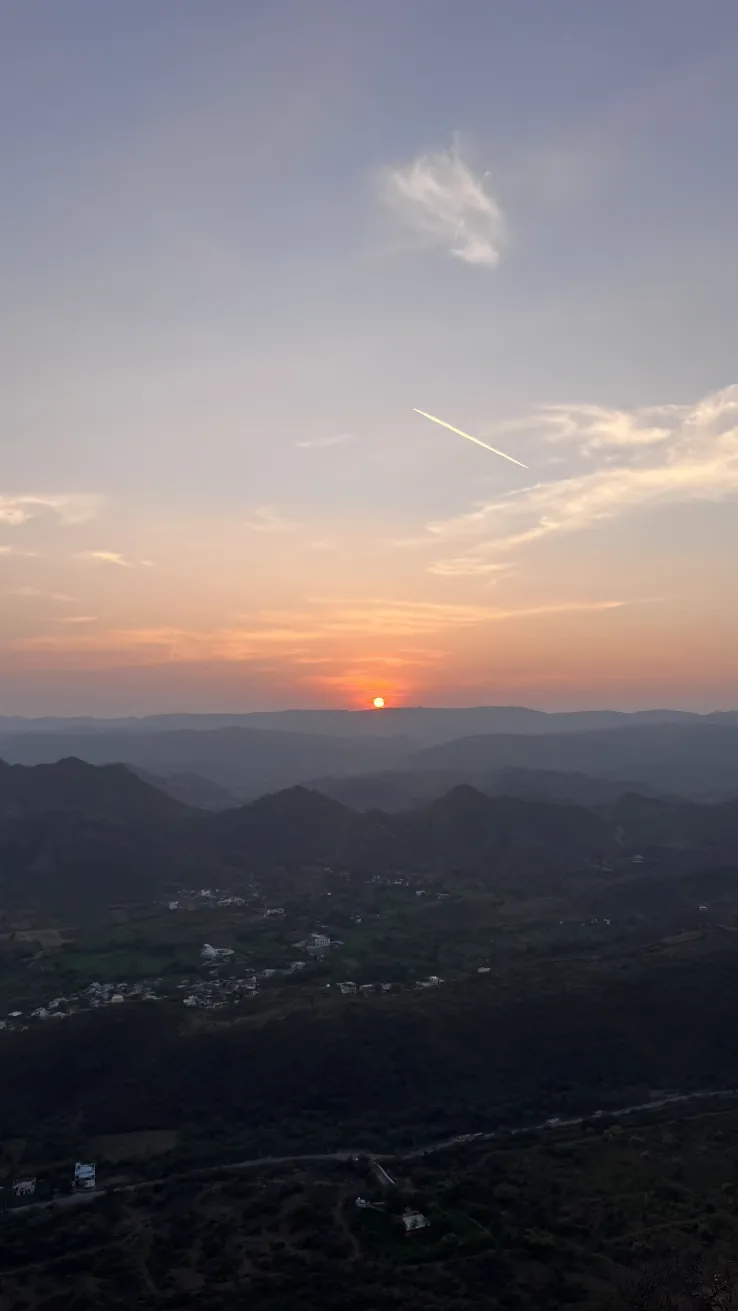 The sun rising over the layered Aravalli hills seen from a viewpoint above Udaipur